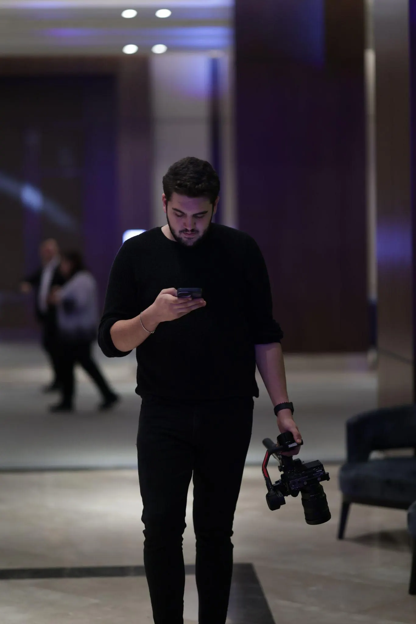 Operator carrying a gimbal between takes