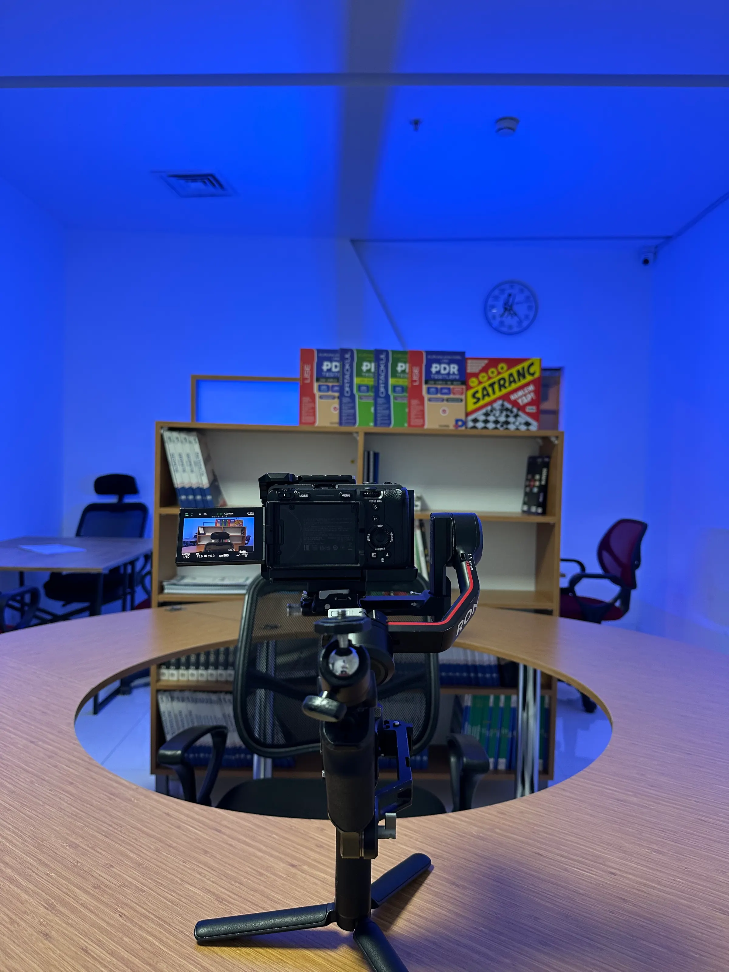 An in-house promo shoot with a gimbal-mounted camera set up on a table
