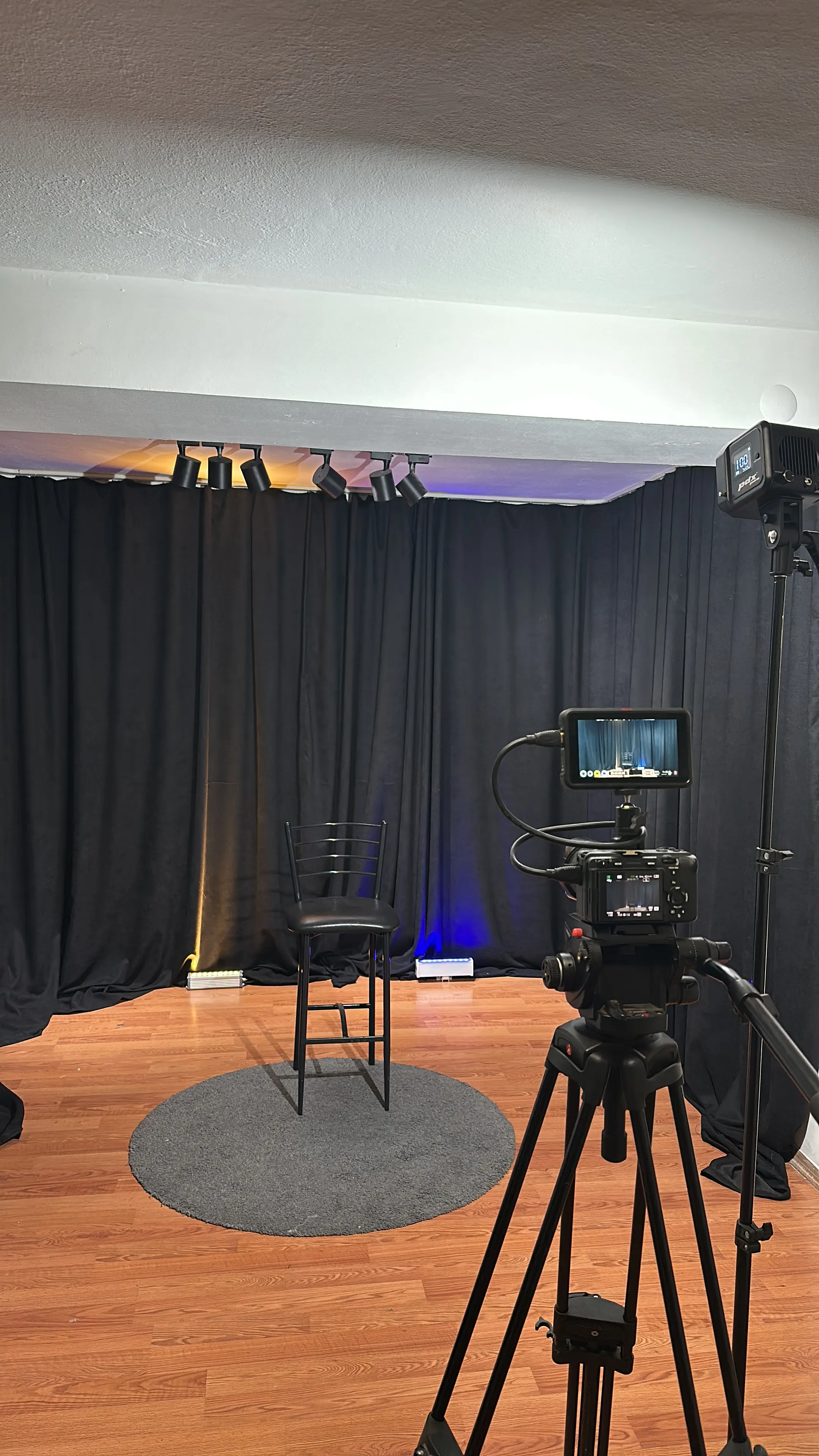A portrait setup on the studio floor with the backdrop and lights ready