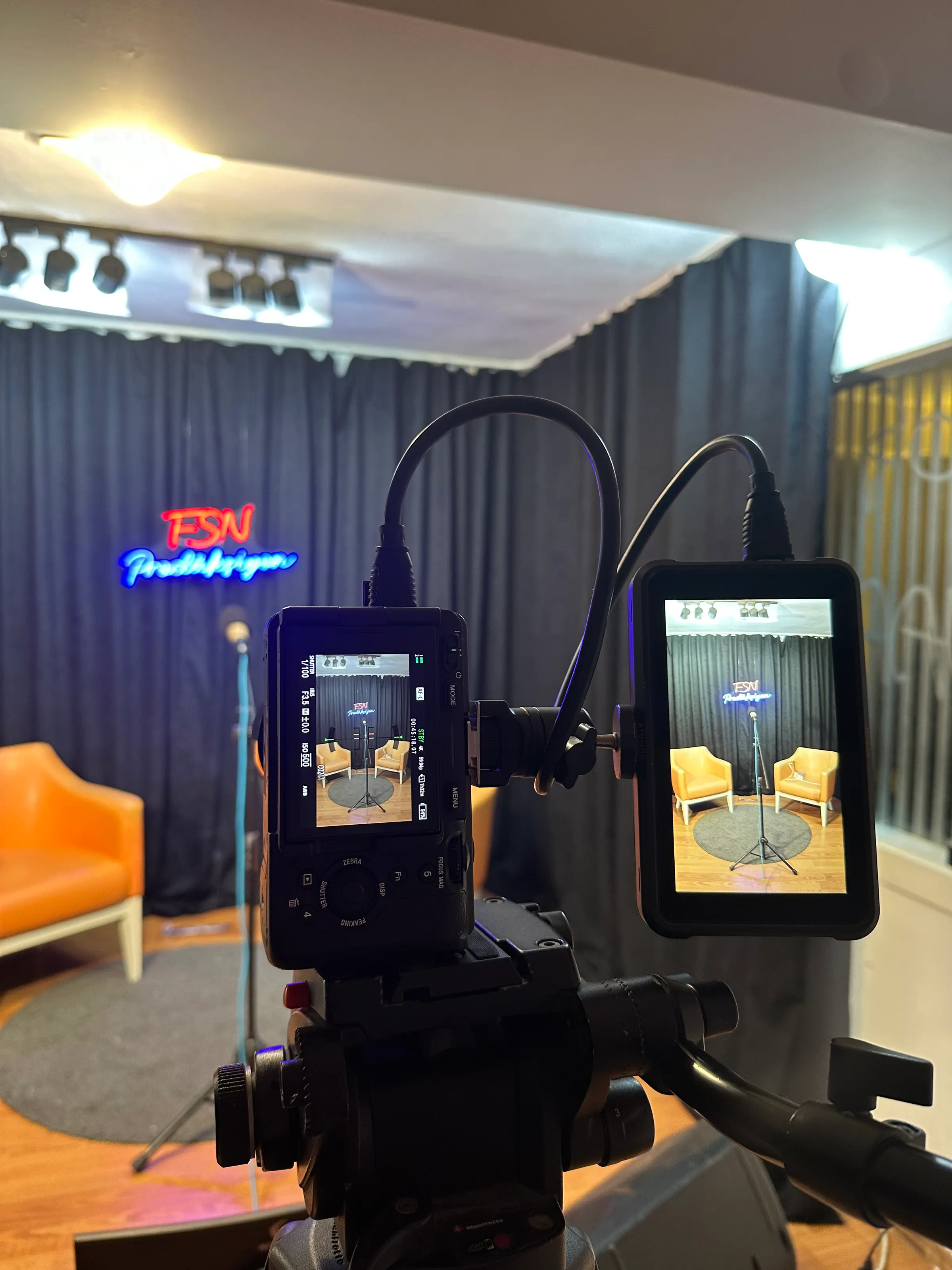 An interview setup in the studio with a camera and field monitor